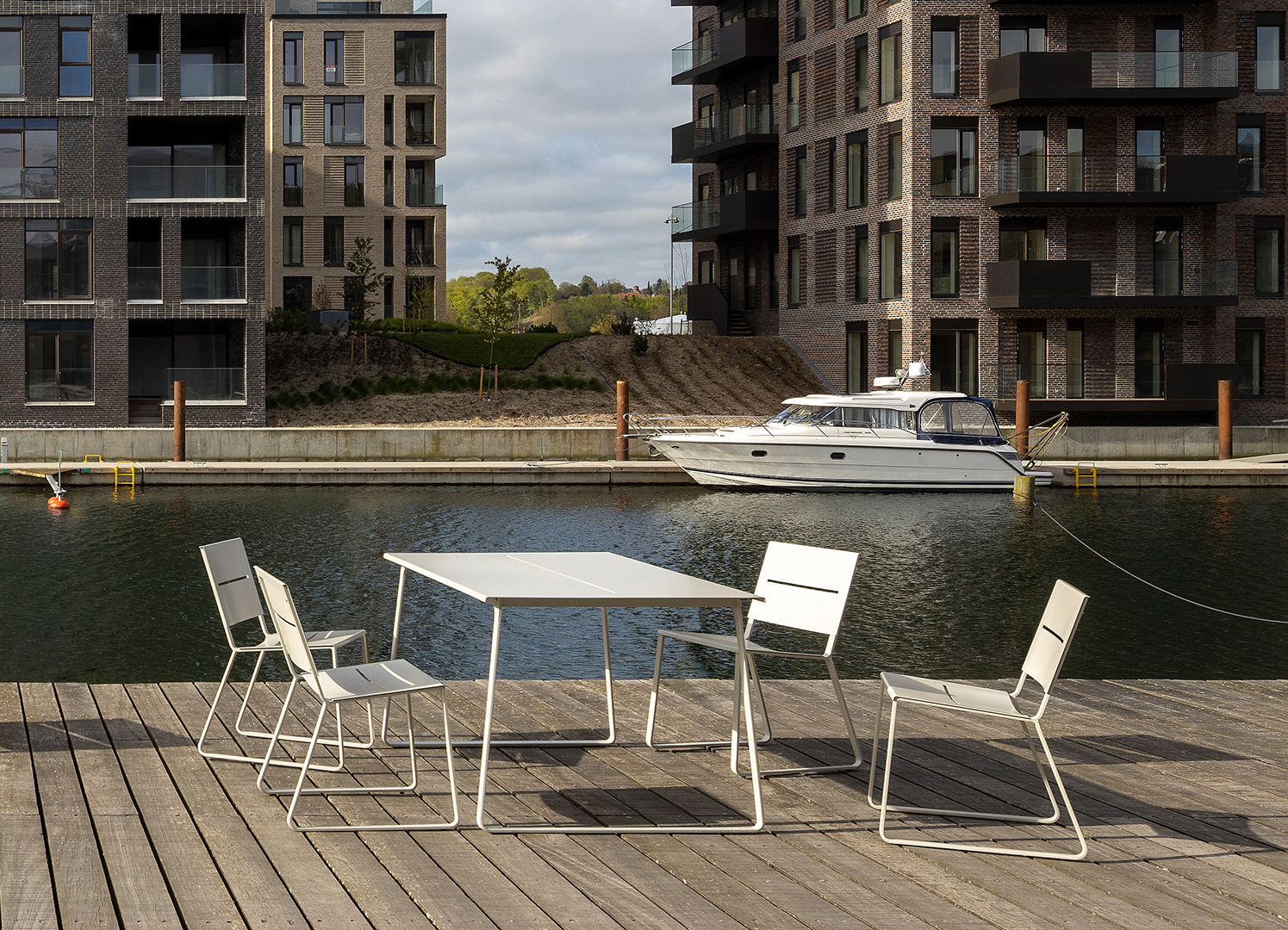 A set of powder coated grey table and chairs seen by the marina