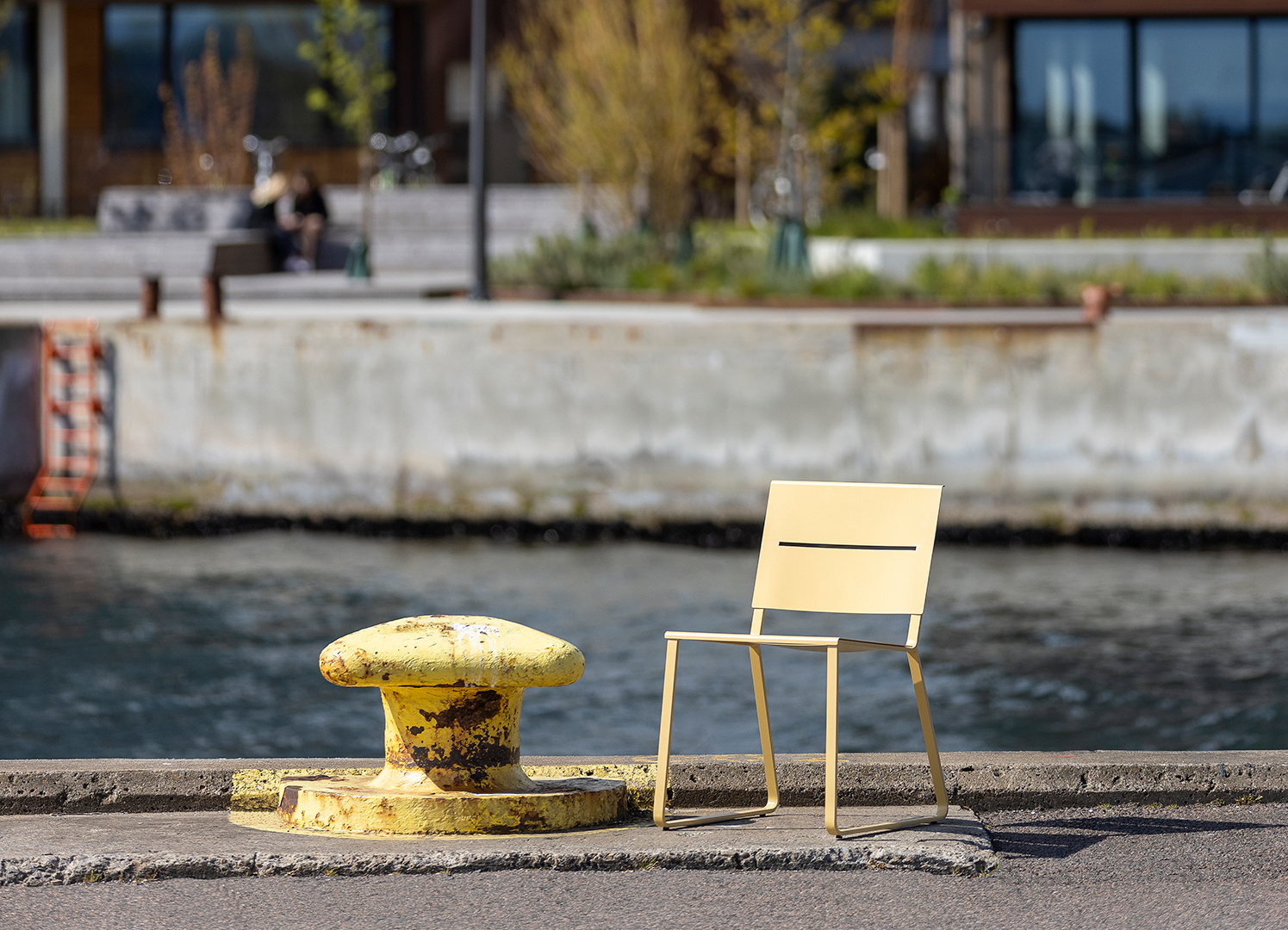 A yellow TERÄS chair on the harbour