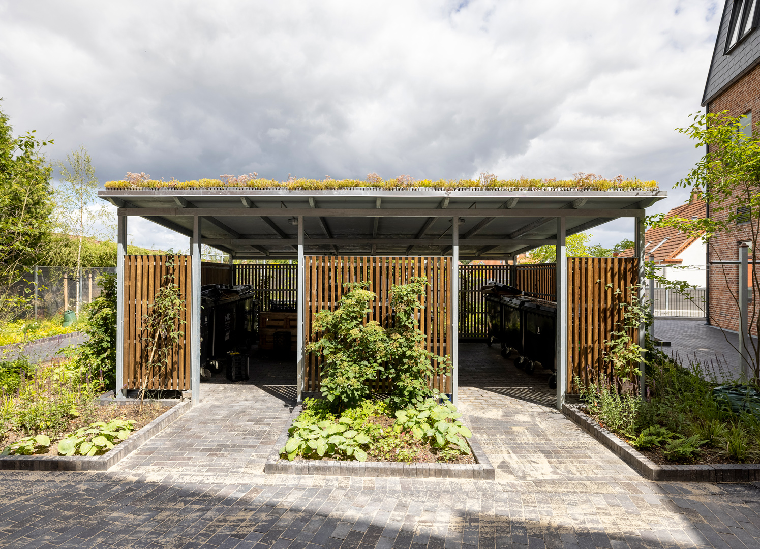 Recycling station with wooden cladding and sedum roof